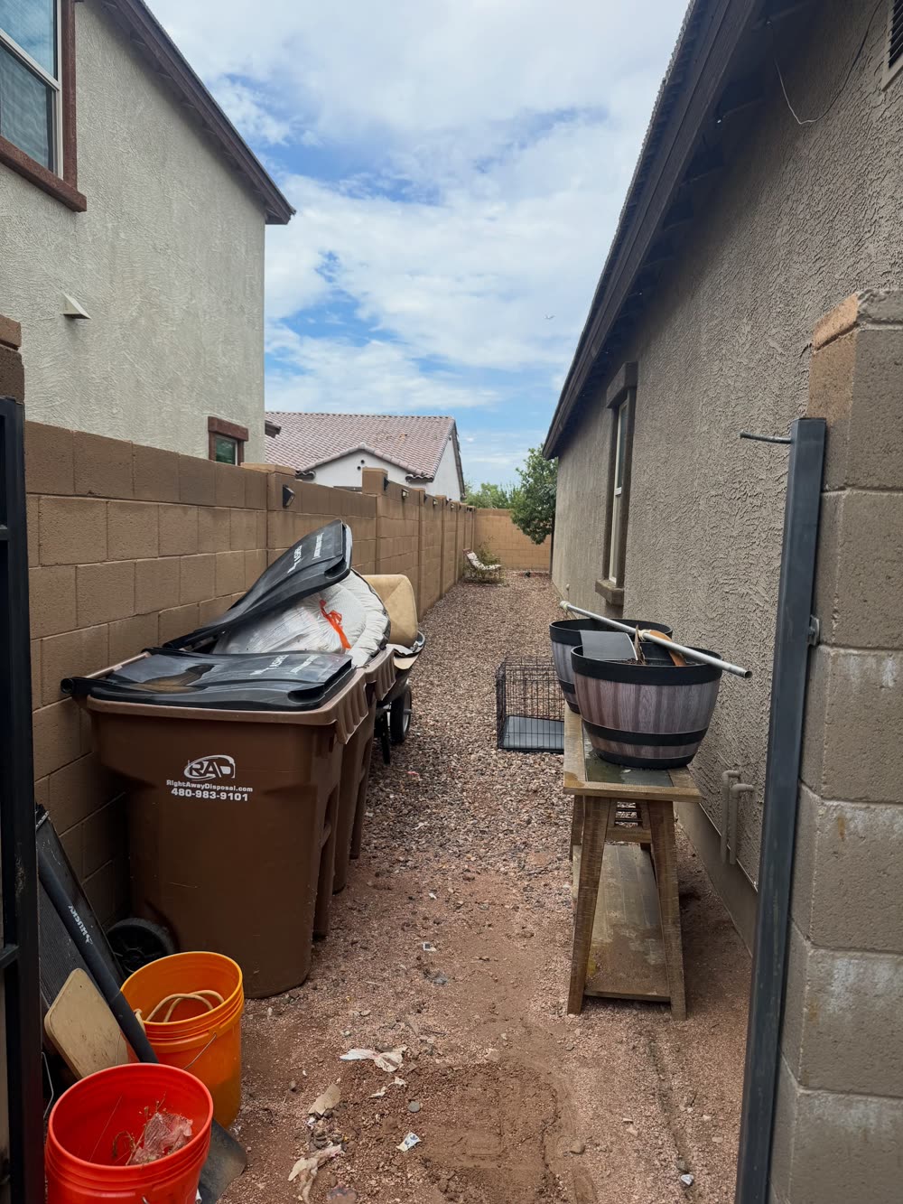 Side yard filled with junk before EJ's cleanout