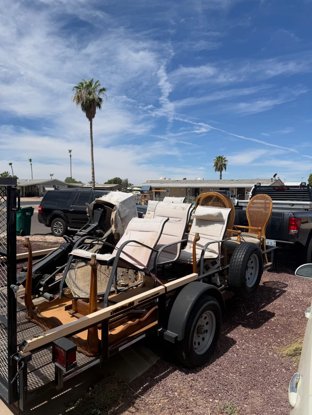EJ's trailer stacked with patio chairs and furniture from a cleanout